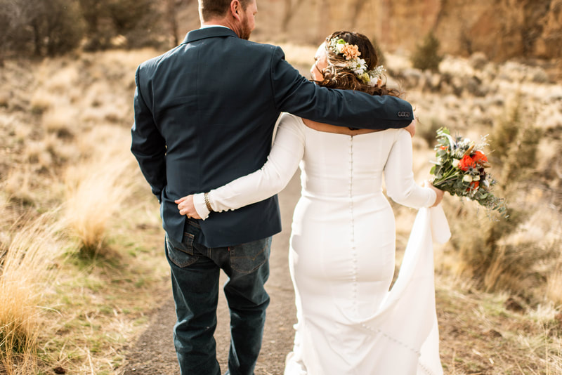 bride and groom hike at Smith Rock State Park in Terrebonne, Oregon