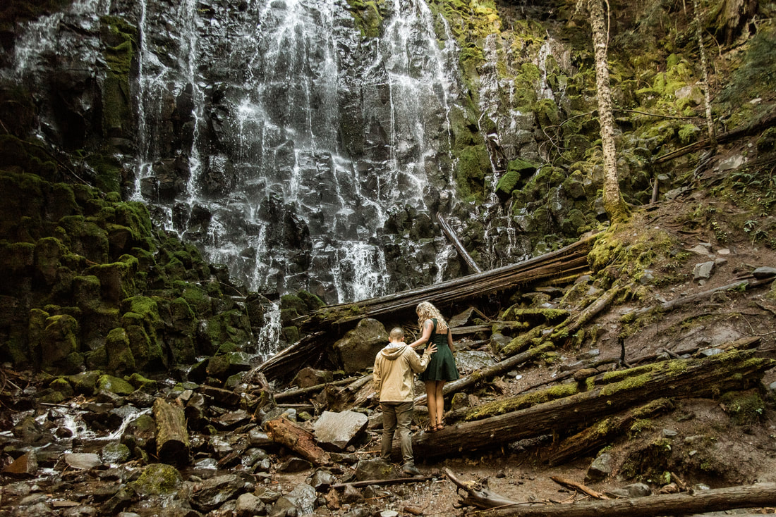 engaged couple walk beneath Ramona Falls on Mt. Hood, Oregon