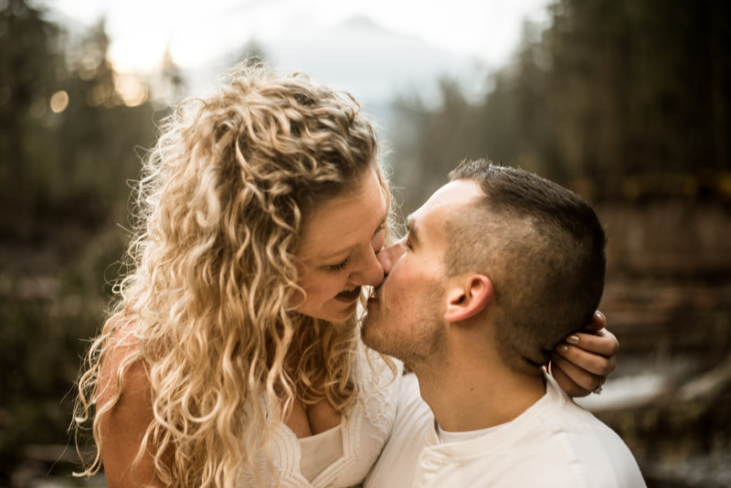 couple kisses in front of Mt. Hood, Oregon for their engagement session