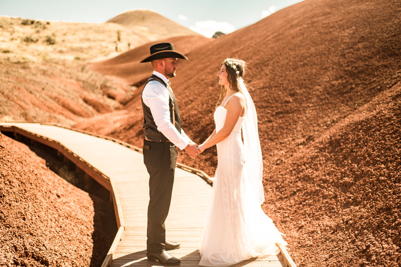 painted hills elopement, oregon elopement of bride and groom in the orange rolling hills of the painted hills